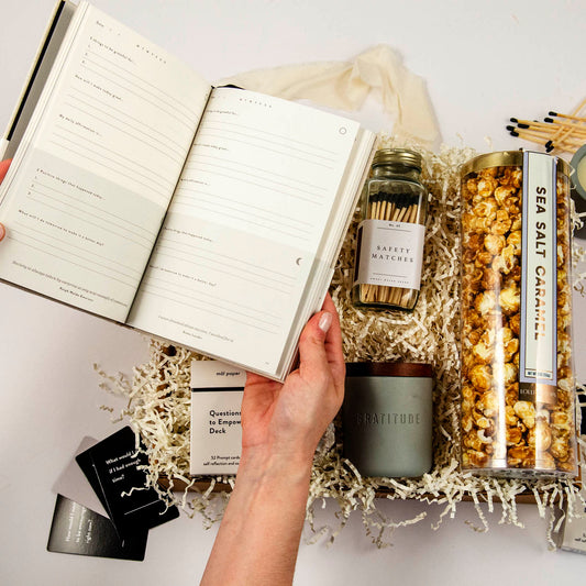 gratitude journal held open over a curated gift set from Batch, a business gifting company